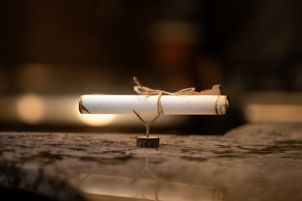 dining menu presented as a rolled up scroll on a miniature tree stump