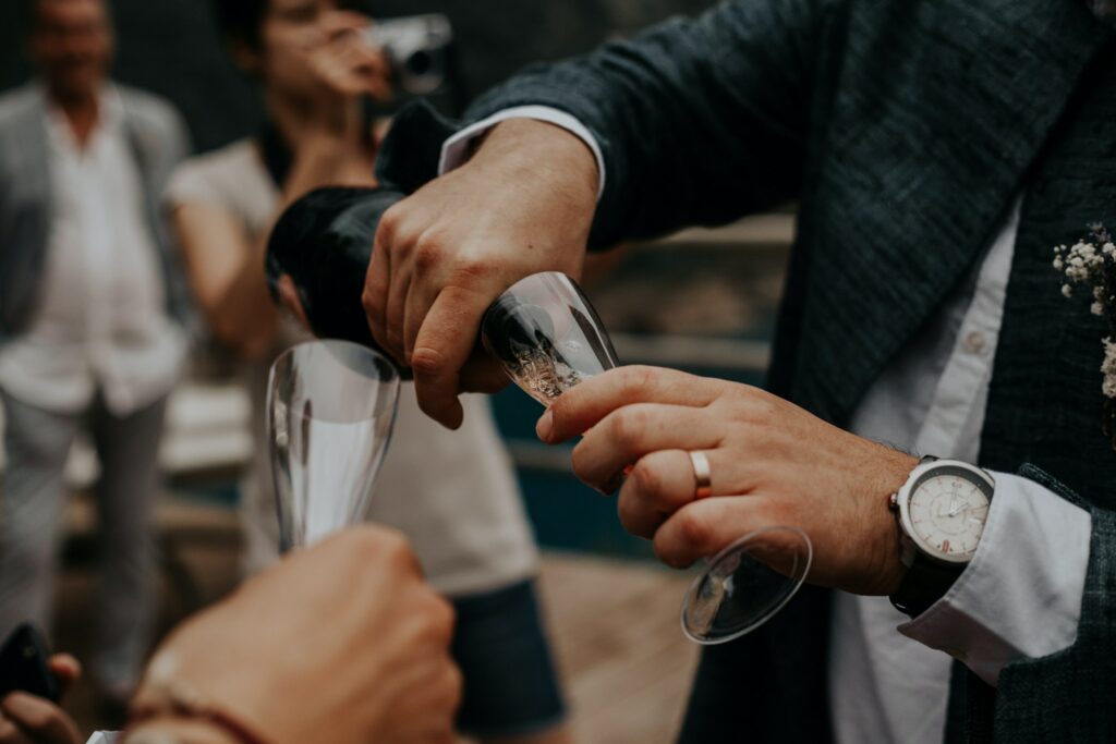 just married couple pouring champagne