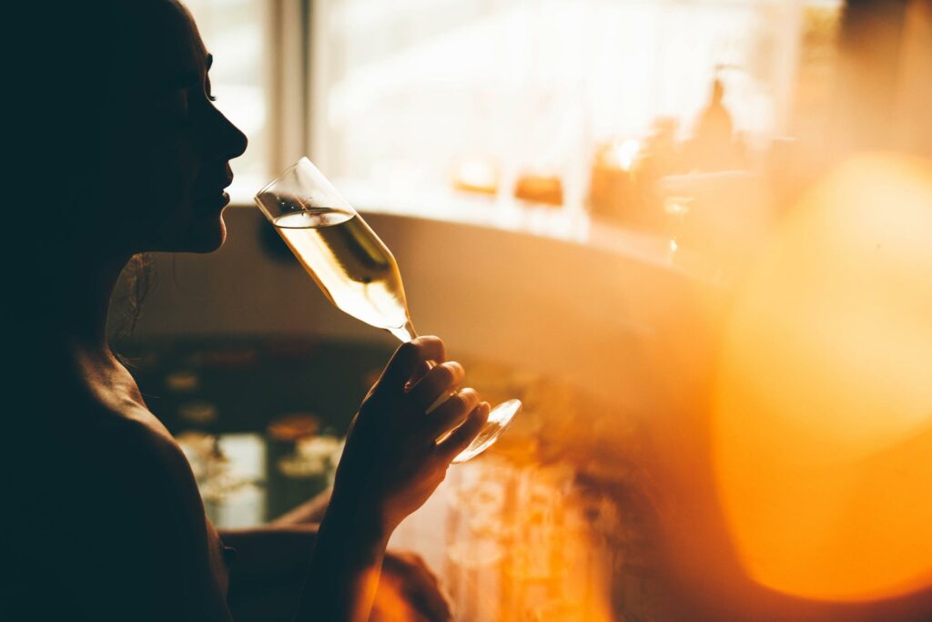 woman sipping champagne in spa